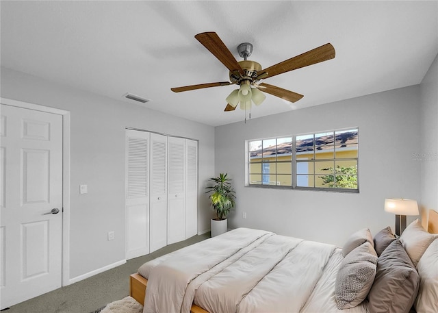 carpeted bedroom featuring a closet and ceiling fan