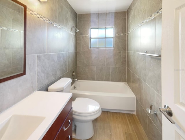 14912 SW 35th Cir, Ocala, FL 34473 - bathroom with wood finished floors, vanity, shower / washtub combination, tile walls, and toilet