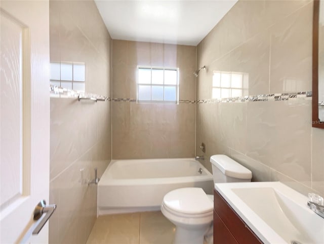 14912 SW 35th Cir, Ocala, FL 34473 - bathroom featuring tile walls, tub / shower combination, vanity, toilet, and tile patterned flooring