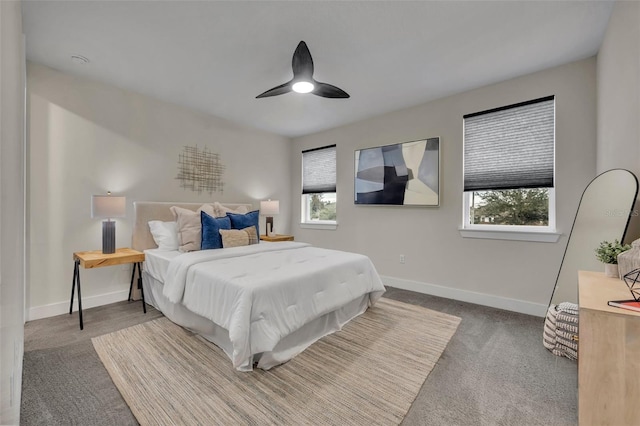 carpeted bedroom with multiple windows and ceiling fan