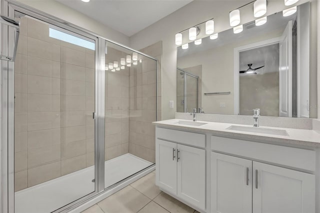 bathroom featuring tile patterned floors, ceiling fan, vanity, and a shower with shower door