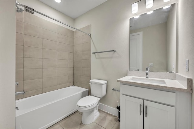 full bathroom featuring toilet, tile patterned floors, vanity, and tiled shower / bath combo