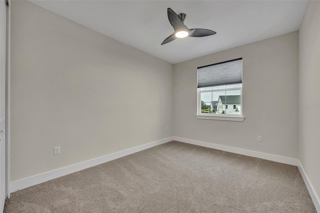 spare room featuring ceiling fan and carpet floors