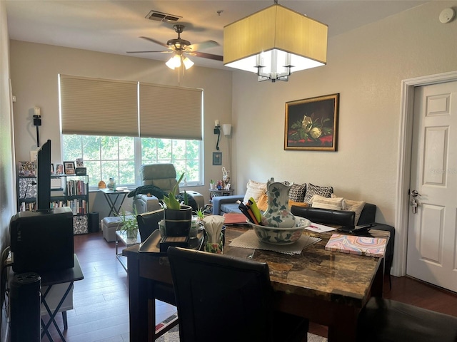 dining area featuring ceiling fan and dark hardwood / wood-style flooring