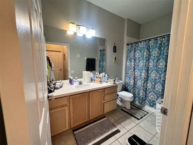 bathroom featuring tile patterned flooring, vanity, and toilet