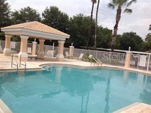 view of swimming pool featuring a gazebo and a patio