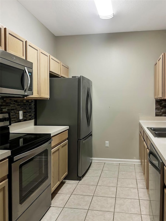 13536 Turtle Marsh Loop Unit 538, Orlando, FL 32837 - kitchen with appliances with stainless steel finishes, tasteful backsplash, light countertops, and light tile patterned floors