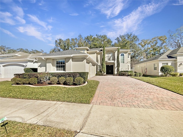 view of front of house with a front lawn and a garage