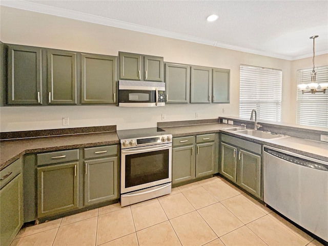 kitchen featuring ornamental molding, stainless steel appliances, sink, light tile patterned floors, and hanging light fixtures