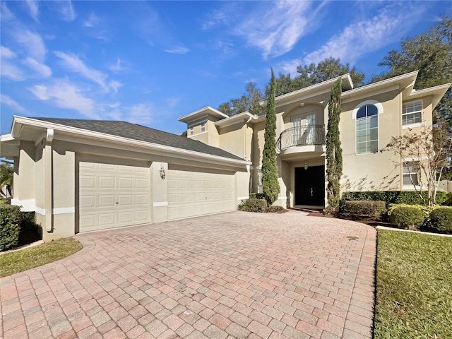 view of front of property featuring a balcony and a garage