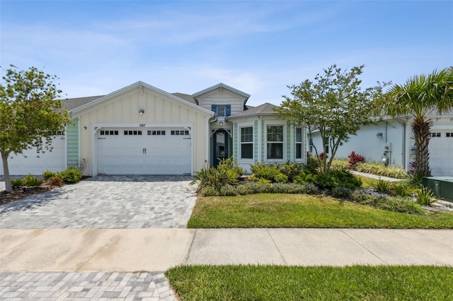 ranch-style home with a front yard and a garage