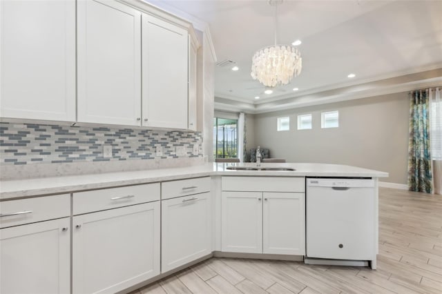 kitchen with white dishwasher, white cabinets, and sink