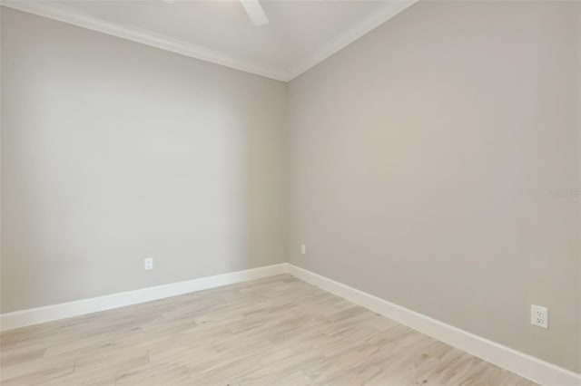 spare room featuring light hardwood / wood-style flooring and ornamental molding