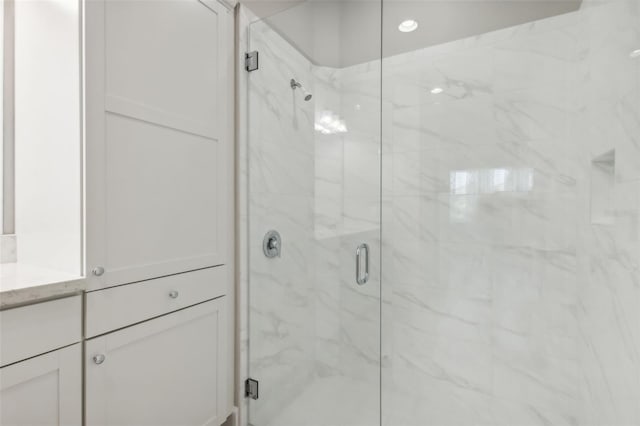 bathroom featuring vanity and an enclosed shower