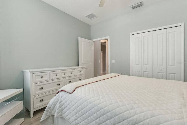 bedroom featuring ceiling fan, light hardwood / wood-style floors, and a closet