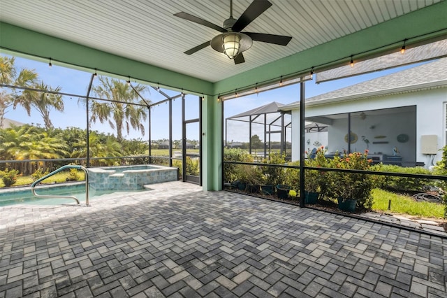 unfurnished sunroom featuring ceiling fan and a swimming pool