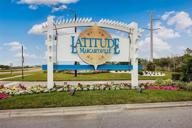 community / neighborhood sign with a yard