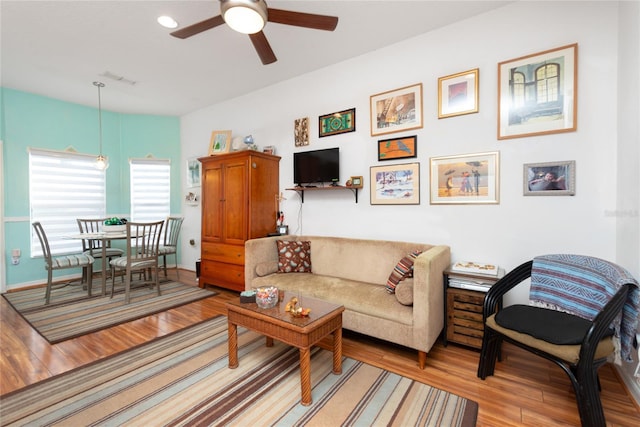 living room with ceiling fan and light wood-type flooring