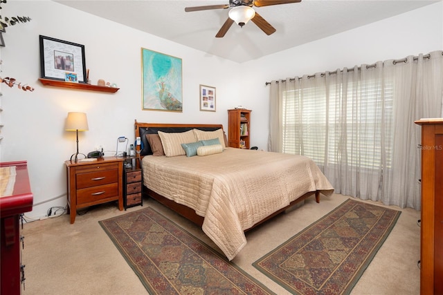 bedroom with ceiling fan and light carpet