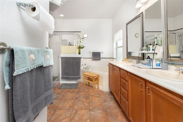 bathroom featuring vanity and independent shower and bath