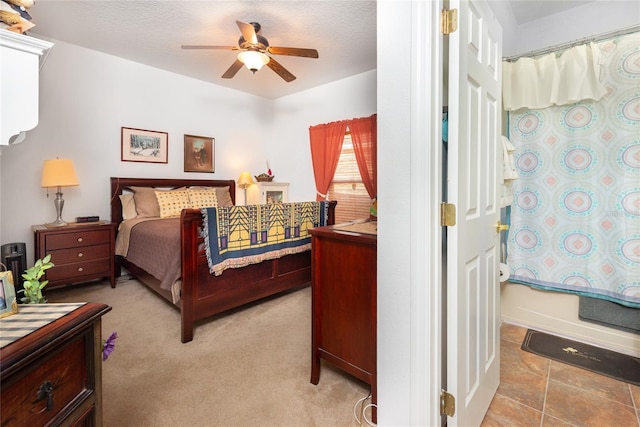 bedroom with ceiling fan and a textured ceiling