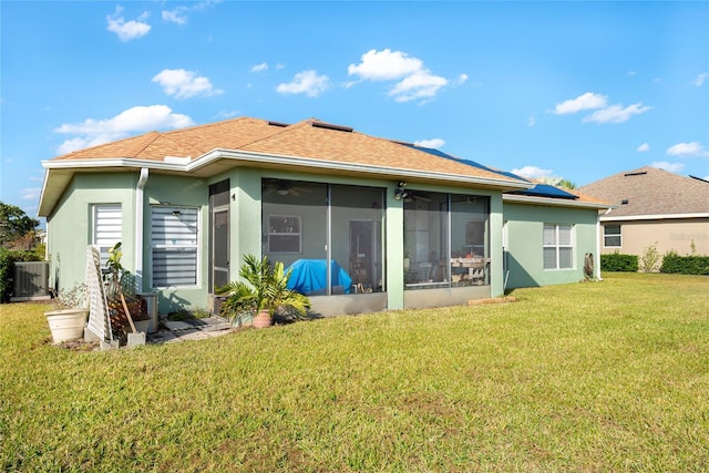 rear view of house with a sunroom, a yard, and central air condition unit