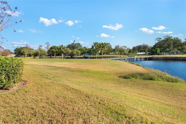 surrounding community with a yard and a water view