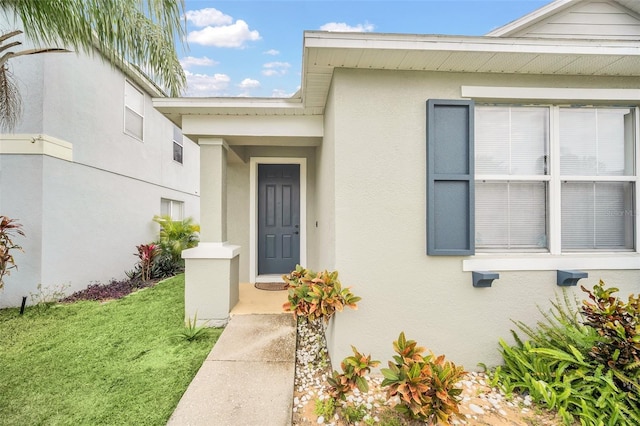 doorway to property with a yard