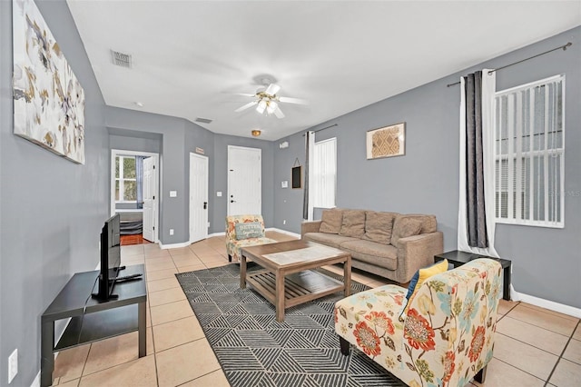 living room with ceiling fan and light tile patterned flooring