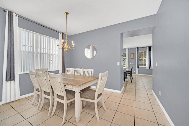 dining space with light tile patterned floors and a notable chandelier