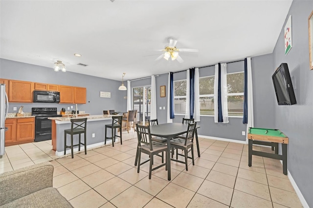 tiled dining room featuring ceiling fan and billiards