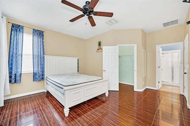 unfurnished bedroom featuring a closet, a spacious closet, and ceiling fan