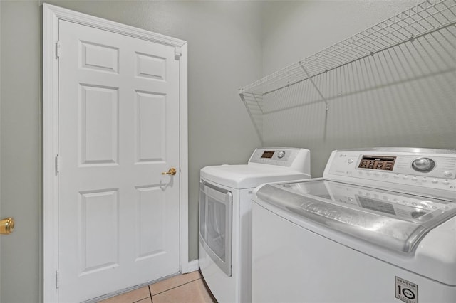 laundry area featuring light tile patterned flooring and washer and dryer