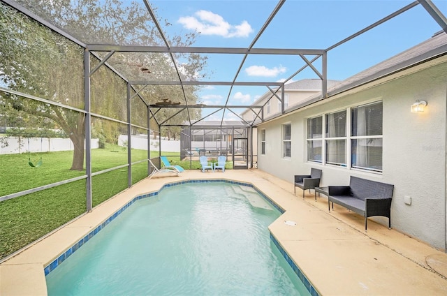 view of swimming pool featuring glass enclosure, a patio area, and a yard