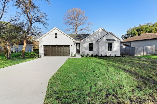 modern farmhouse style home featuring a garage and a front lawn