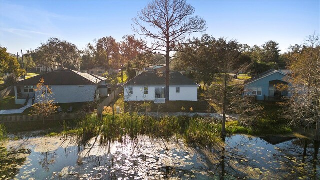 back of property featuring a water view