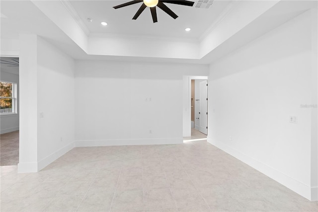 unfurnished room featuring ceiling fan, ornamental molding, and a tray ceiling