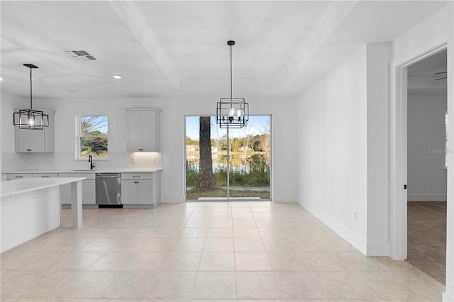 unfurnished dining area featuring a notable chandelier, light tile patterned floors, and sink