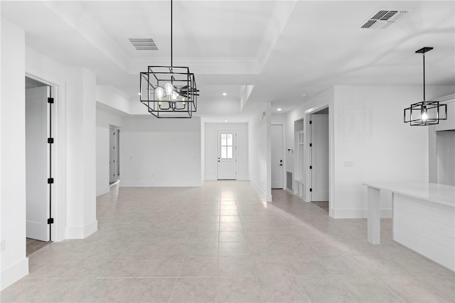 unfurnished dining area with a raised ceiling, crown molding, and light tile patterned flooring