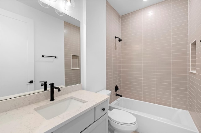 full bathroom with vanity, toilet, and tiled shower / bath