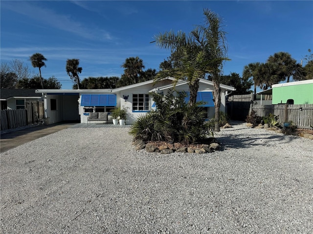 rear view of house featuring a carport