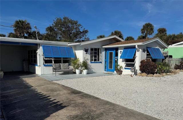 back of property with a carport