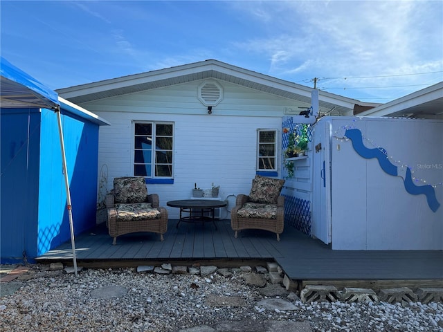 back of property with a wooden deck