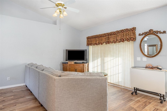 living room with vaulted ceiling, ceiling fan, and hardwood / wood-style flooring