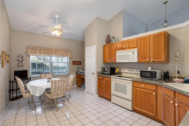 kitchen with ceiling fan, vaulted ceiling, white appliances, hanging light fixtures, and light tile patterned floors