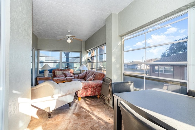 sunroom featuring ceiling fan