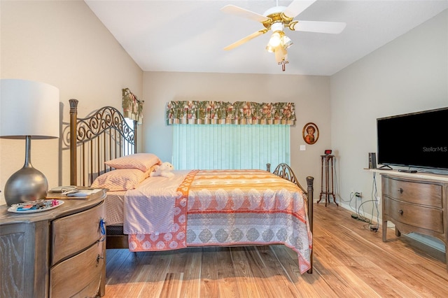 bedroom featuring ceiling fan, wood-type flooring, and multiple windows