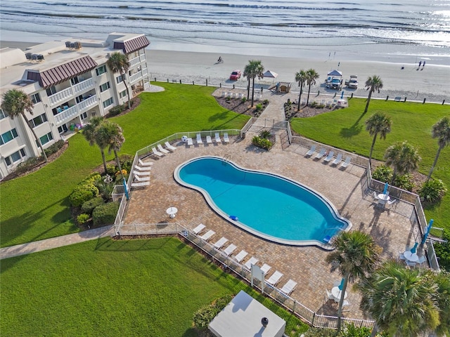 view of pool featuring a view of the beach and a water view