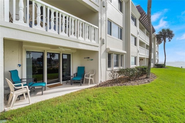 3663 S Atlantic Ave Unit 11D, New Smyrna Beach, FL 32169 - exterior space featuring a lawn, ceiling fan, a balcony, and a patio