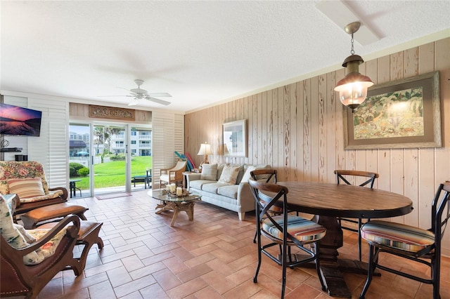 3663 S Atlantic Ave Unit 11D, New Smyrna Beach, FL 32169 - interior space featuring ceiling fan, a textured ceiling, and wooden walls